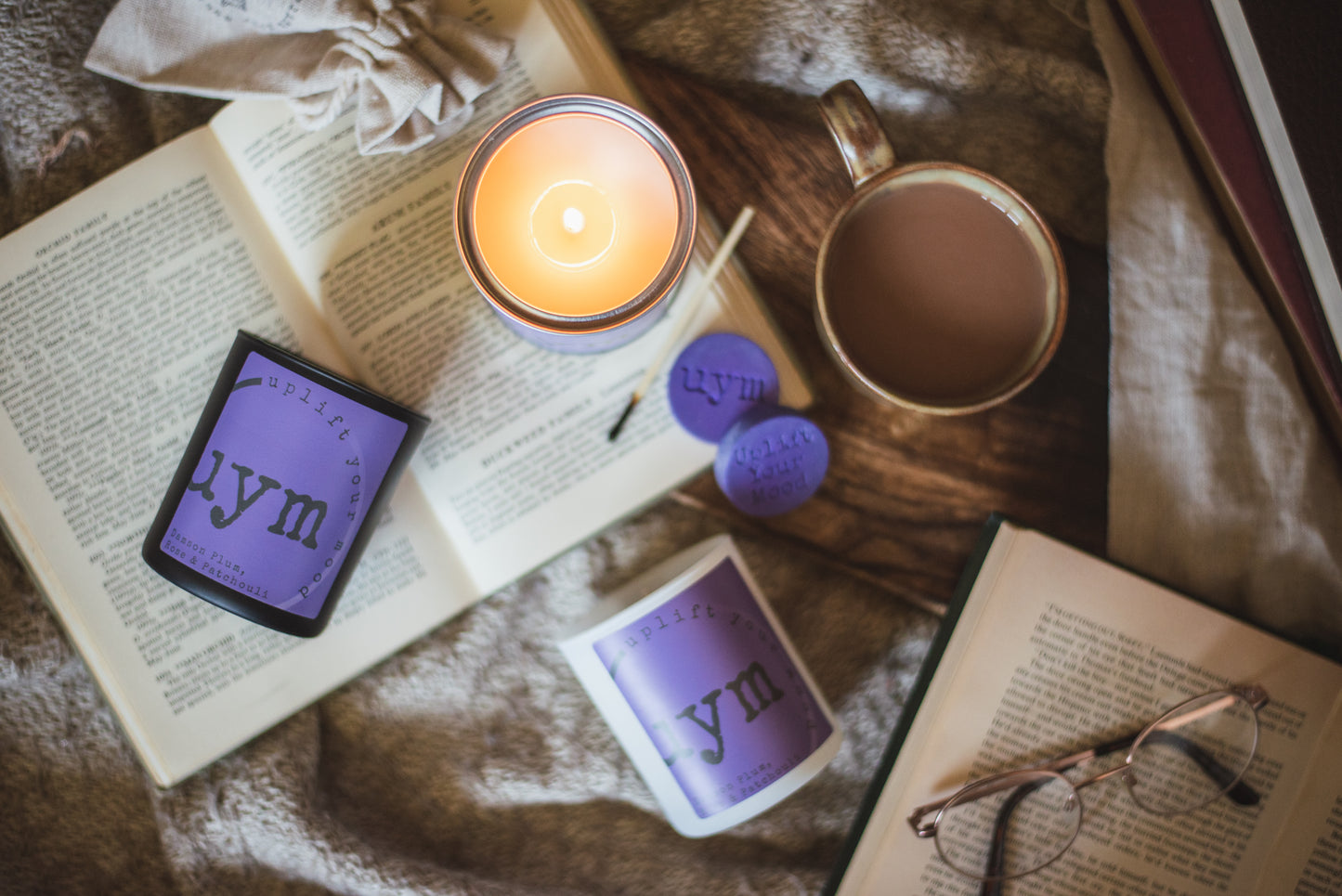 Damson Plum, Rose & Patchouli Candles, highly sceted natural wax, organic cotton wick, metallic tin lighted candle, cosy background. Uplift Your Mood Scents