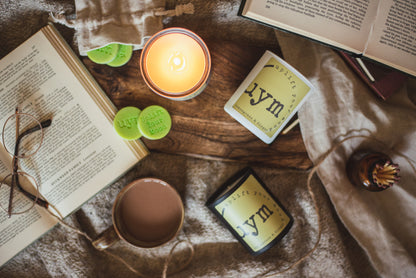 Lemongrass & Ginger Candle, varoius candle containers, scenyed natural wax melts in coton bag, books, a cup of tea, cosy atmosphere, Uplift Your Mood Scents